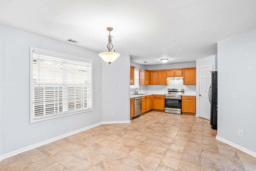 1461 Enchanted Forest Drive Conley, GA 30288 - Photo 11 of 47 a view of a kitchen with a sink and a window