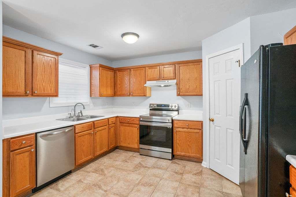 1461 Enchanted Forest Drive Conley, GA 30288 - Photo 15 of 47 a kitchen with stainless steel appliances granite countertop a refrigerator sink and stove
