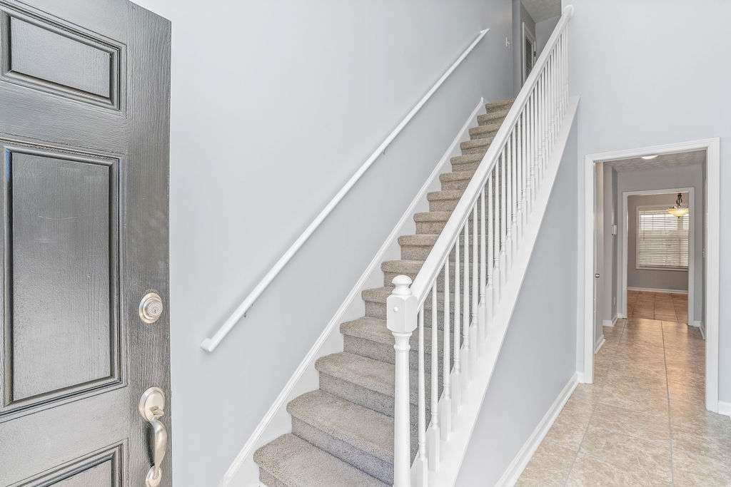 1461 Enchanted Forest Drive Conley, GA 30288 - Photo 2 of 47 a view of staircase with white walls and railing