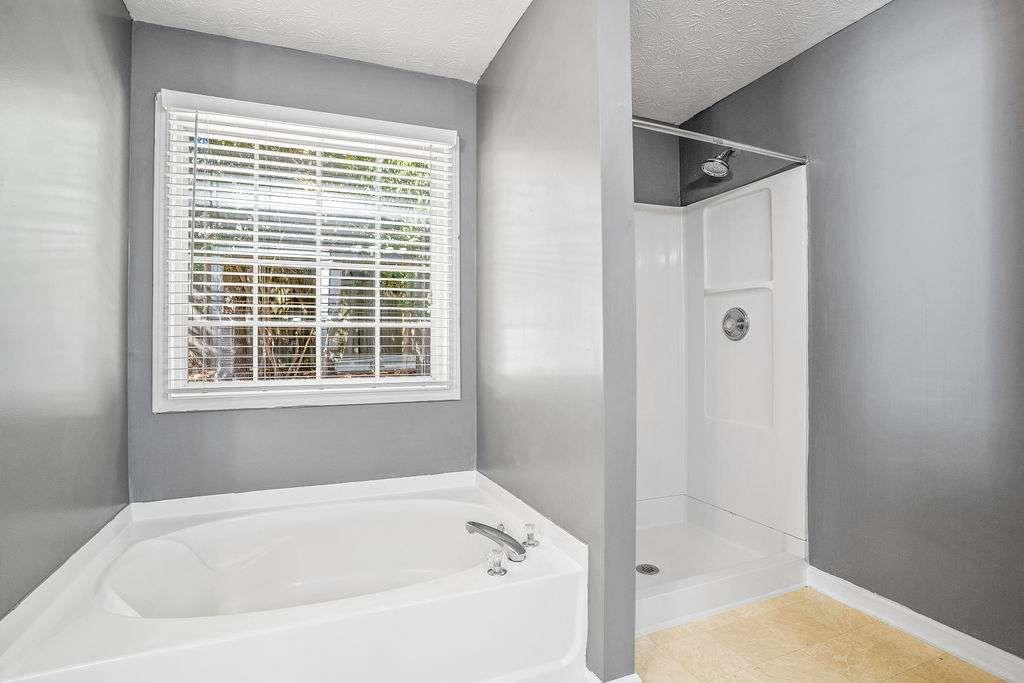 1461 Enchanted Forest Drive Conley, GA 30288 - Photo 31 of 47 a white bath tub sitting next to a shower