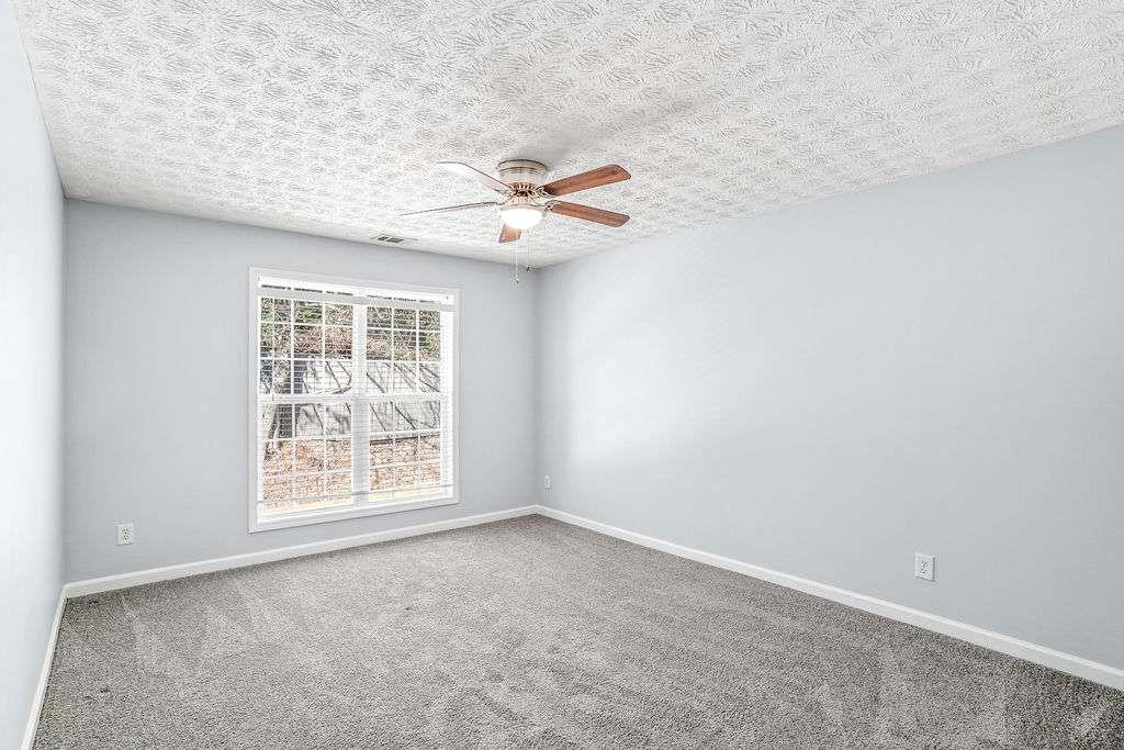 1461 Enchanted Forest Drive Conley, GA 30288 - Photo 35 of 47 an empty room with windows and fan