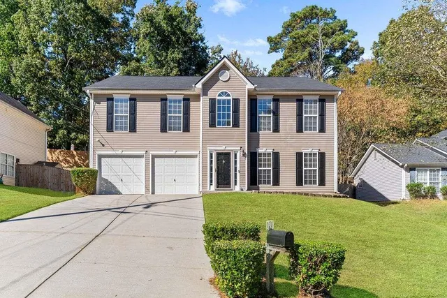 a front view of a house with garden
