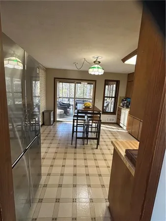 a dining room with furniture and a floor to ceiling window