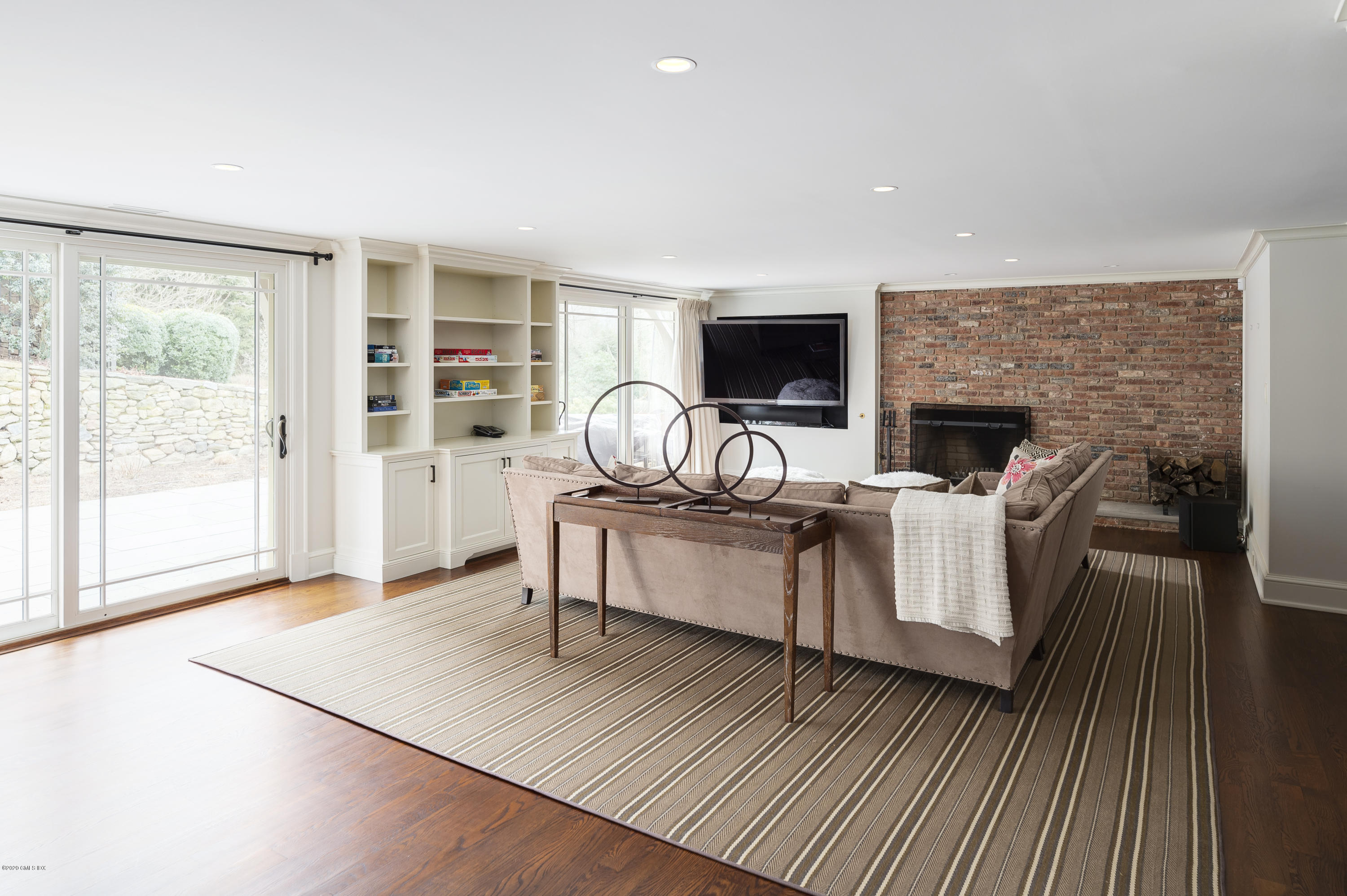 4 Doverton Drive Greenwich, CT 06831 - Photo 11 of 17 a living room with furniture a flat screen tv and a fireplace