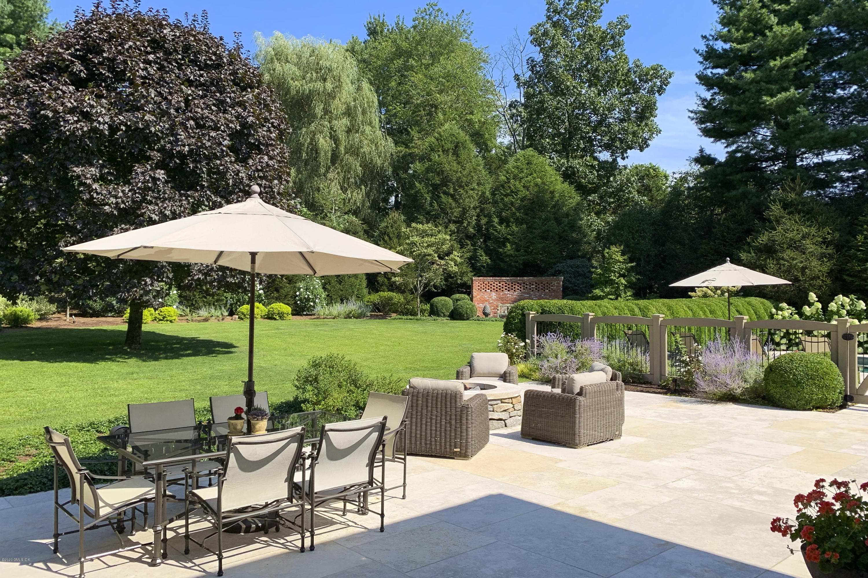 4 Doverton Drive Greenwich, CT 06831 - Photo 13 of 17 a view of table and chairs under an umbrella