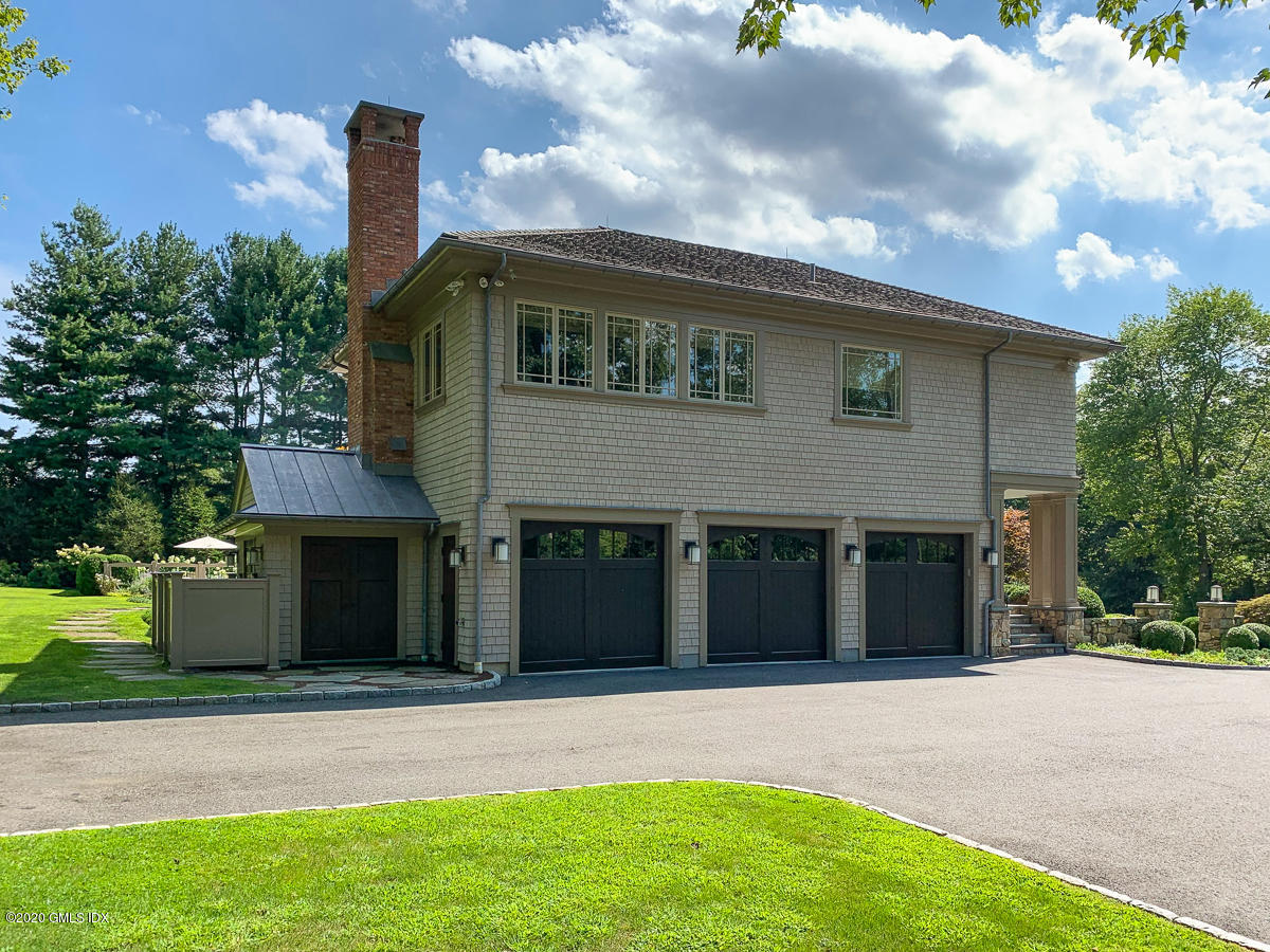 4 Doverton Drive Greenwich, CT 06831 - Photo 15 of 17 a front view of a house with a garden