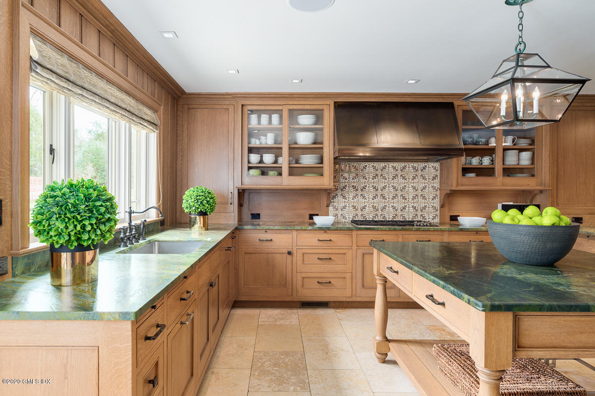 4 Doverton Drive Greenwich, CT 06831 - Photo 7 of 17 a kitchen with stainless steel appliances granite countertop a sink and a wooden floors