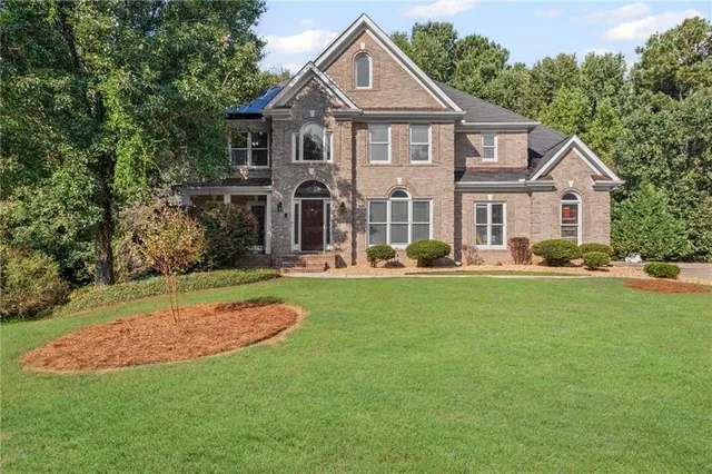 a front view of a house with a yard
