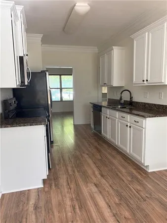 a kitchen with a sink stove and cabinets