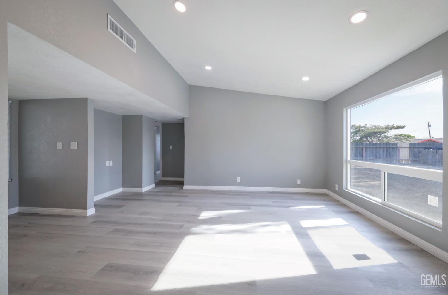 Undisclosed Address Bakersfield, CA 93306 - Photo 11 of 44 a view of an empty room with wooden floor and a window