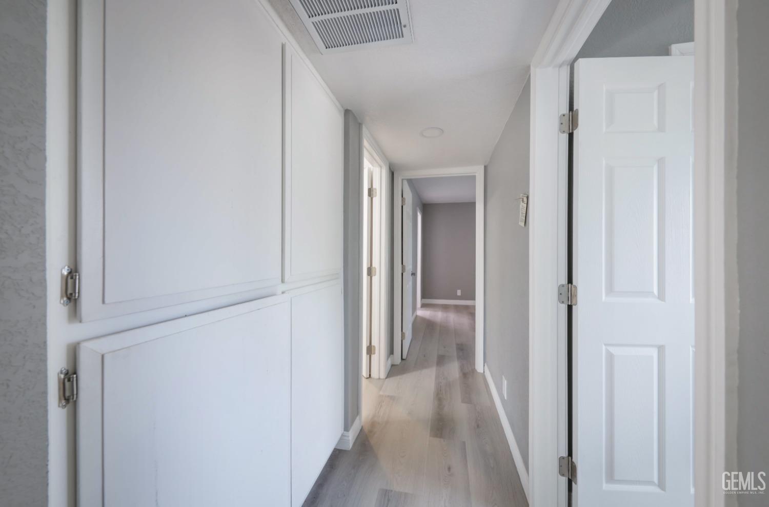 Undisclosed Address Bakersfield, CA 93306 - Photo 13 of 44 a view of a hallway with a wooden door