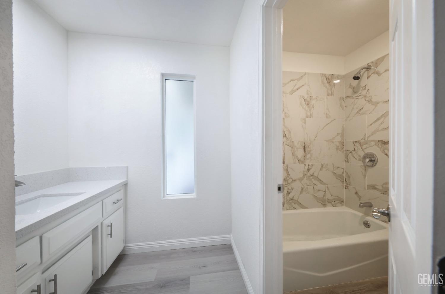 Undisclosed Address Bakersfield, CA 93306 - Photo 15 of 44 a bathroom with a tub sink shower and a mirror