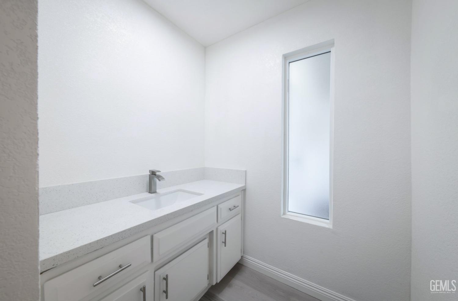 Undisclosed Address Bakersfield, CA 93306 - Photo 16 of 44 a bathroom with a sink and a window
