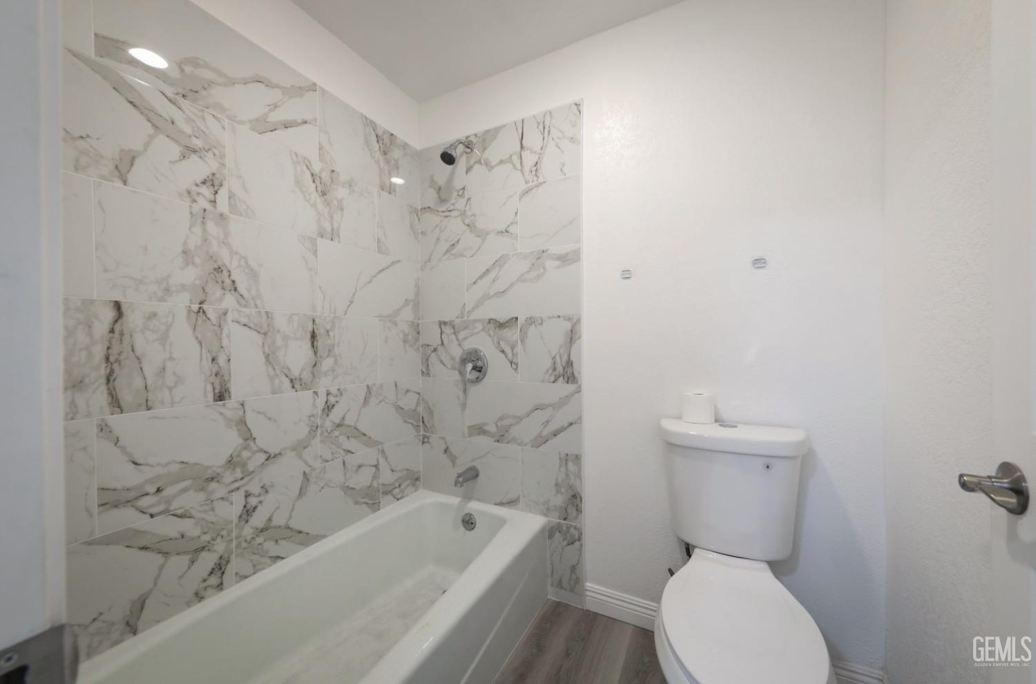 Undisclosed Address Bakersfield, CA 93306 - Photo 17 of 44 a bathroom with a toilet and a bathtub