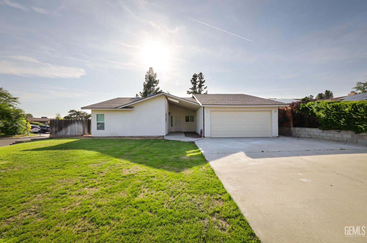 Undisclosed Address Bakersfield, CA 93306 - Photo 2 of 44 a front view of a house with garden