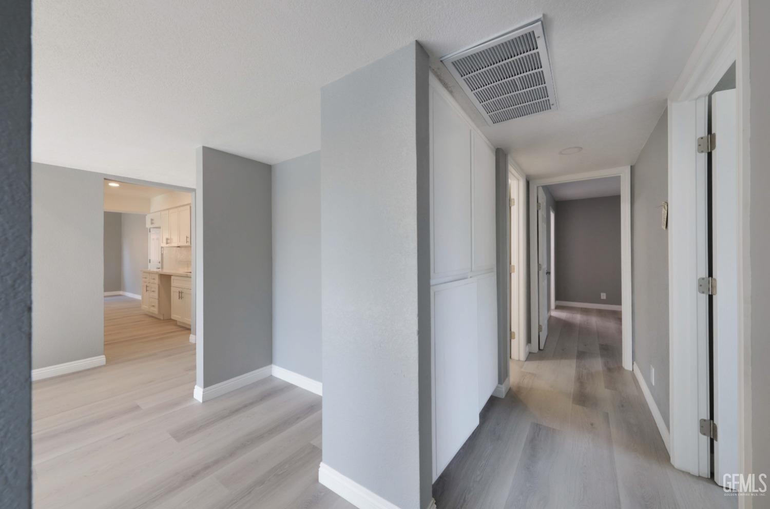 Undisclosed Address Bakersfield, CA 93306 - Photo 23 of 44 a view of a hallway with wooden floor