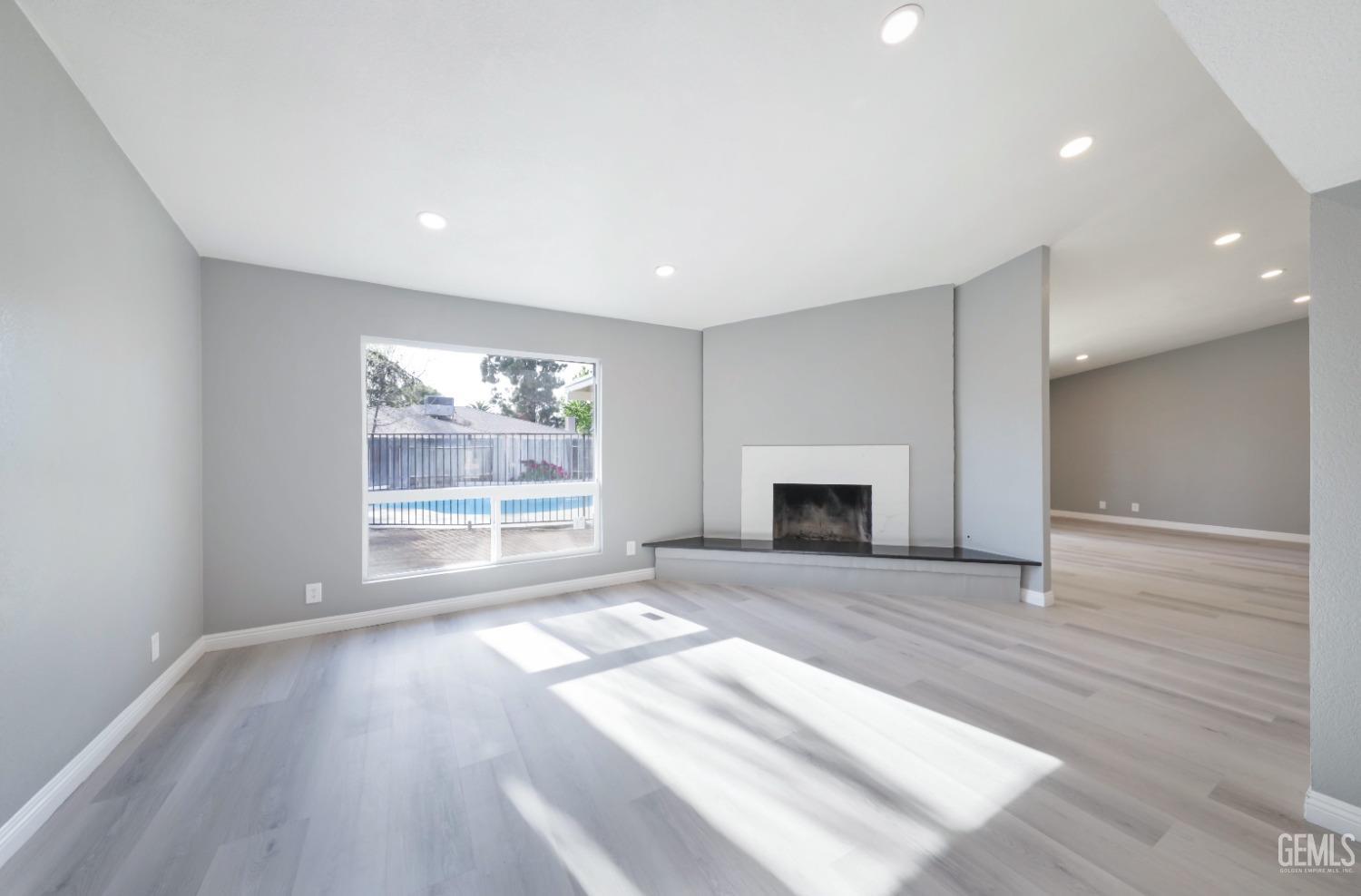 Undisclosed Address Bakersfield, CA 93306 - Photo 25 of 44 wooden floor fireplace and windows in an empty room