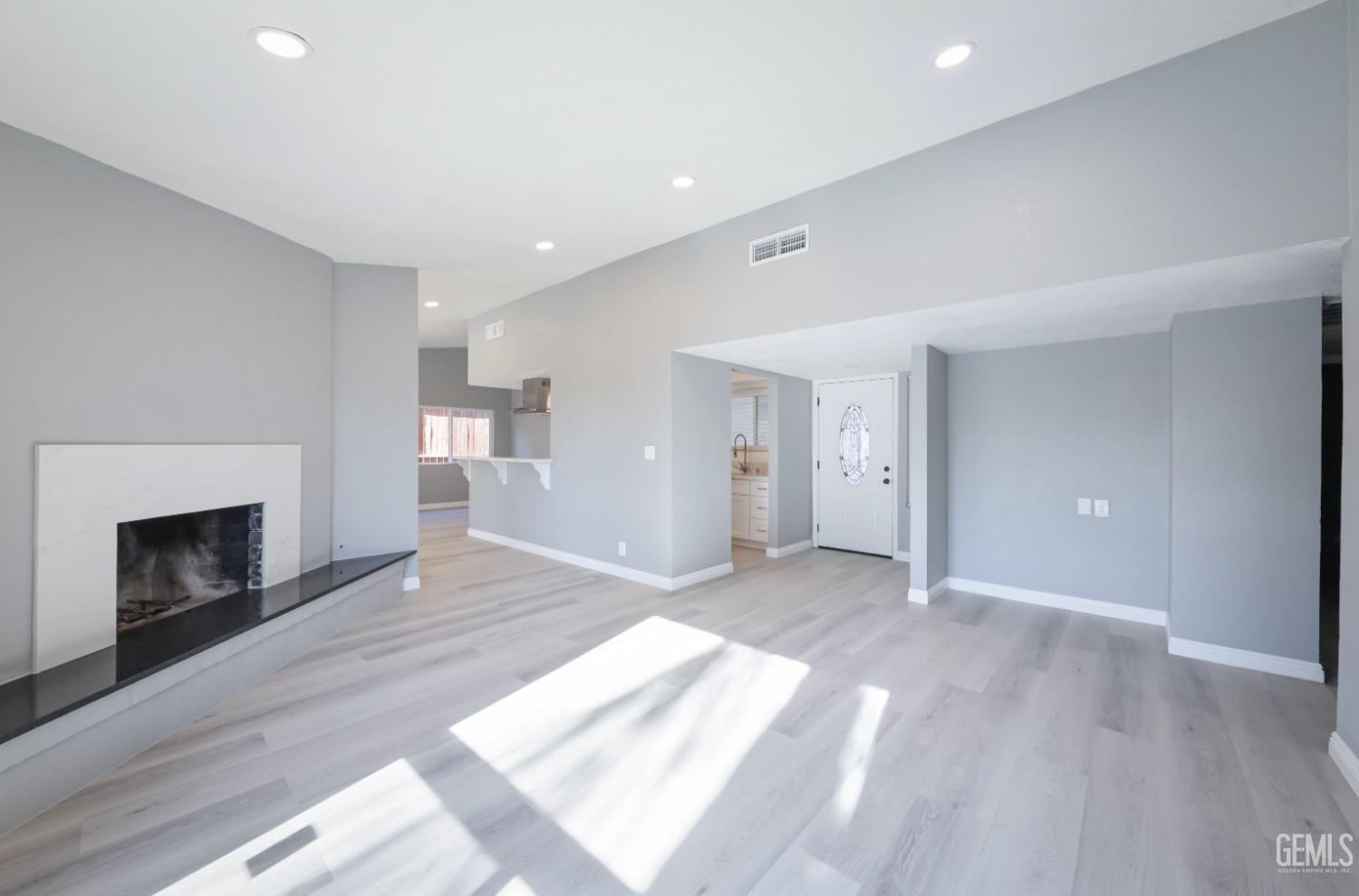 Undisclosed Address Bakersfield, CA 93306 - Photo 26 of 44 a view of empty room with wooden floor and fireplace