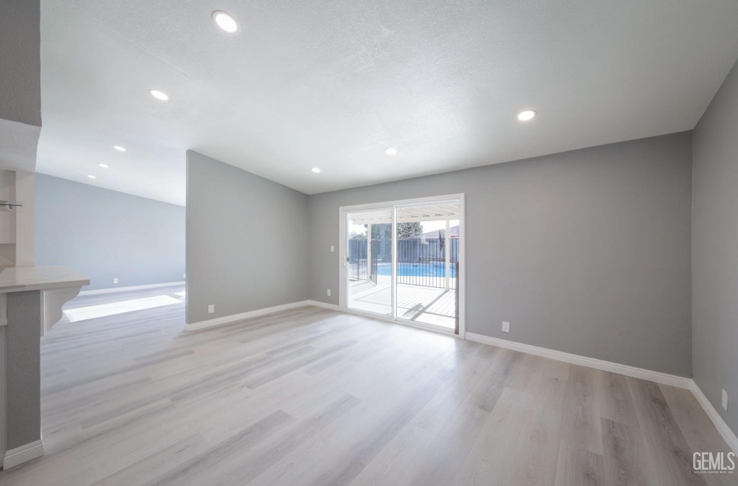 Undisclosed Address Bakersfield, CA 93306 - Photo 33 of 44 an empty room with wooden floor and windows