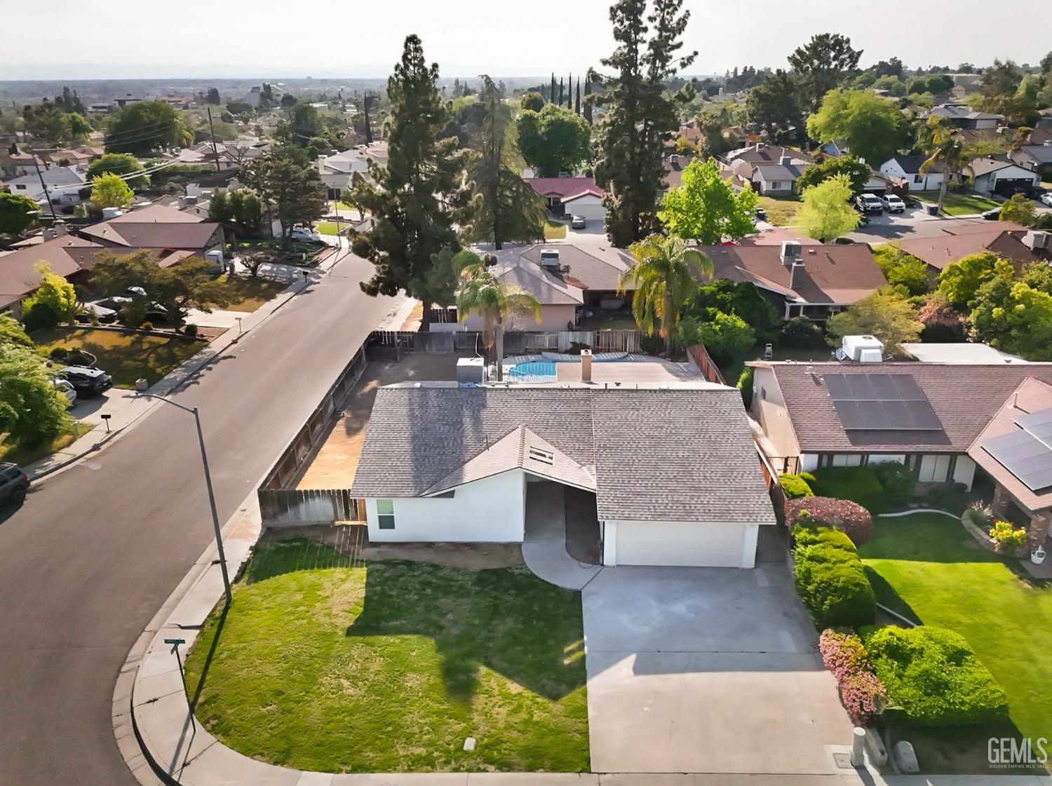 Undisclosed Address Bakersfield, CA 93306 - Photo 8 of 44 a view of a swimming pool with a yard and seating area