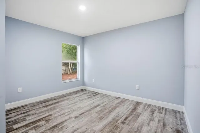 a view of room with window and hardwood floor