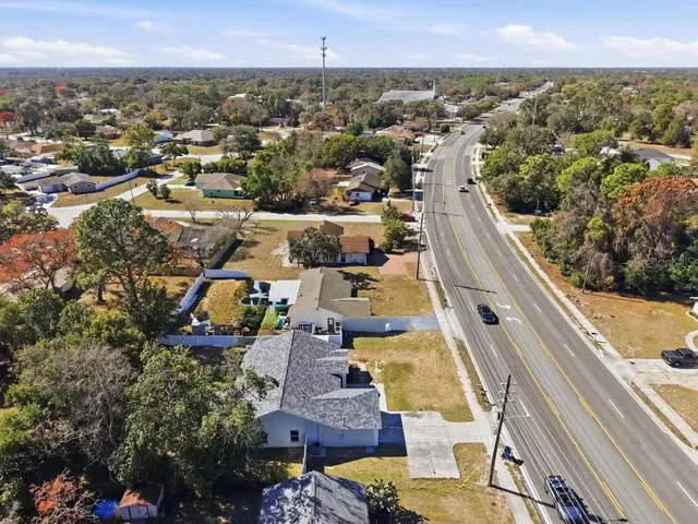 an aerial view of residential houses with outdoor space