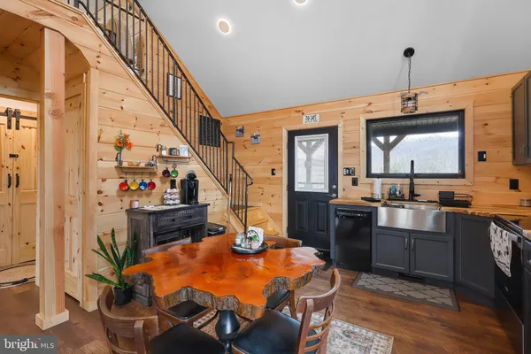 a kitchen with a sink appliances and cabinets