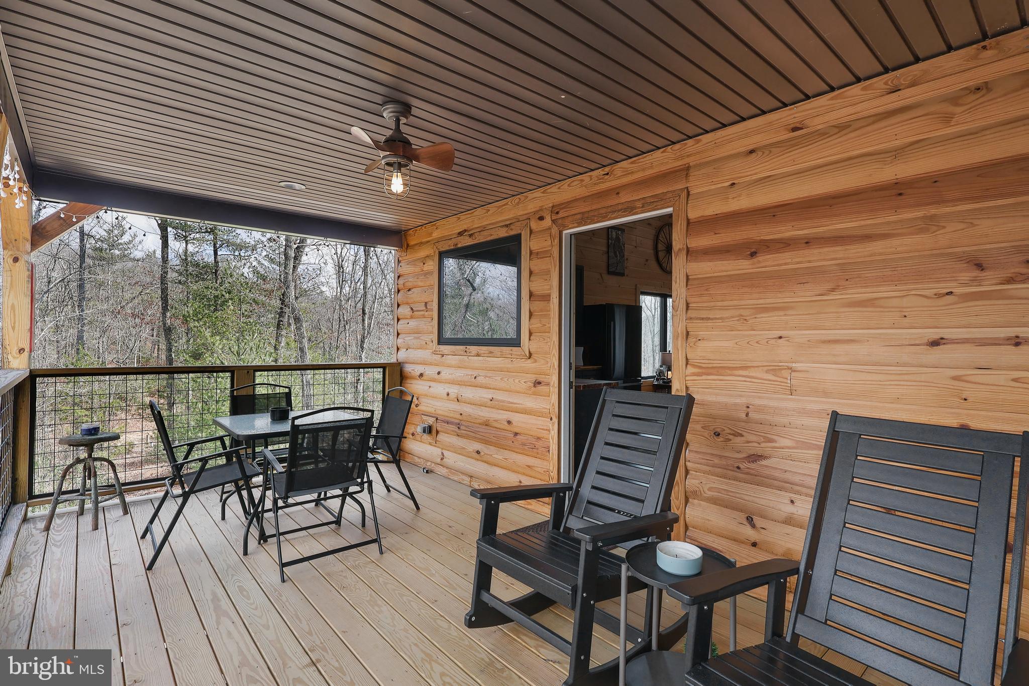 1823 Desert Road Reva, VA 22735 - Photo 15 of 28 a view of a patio with table and chairs and wooden floor