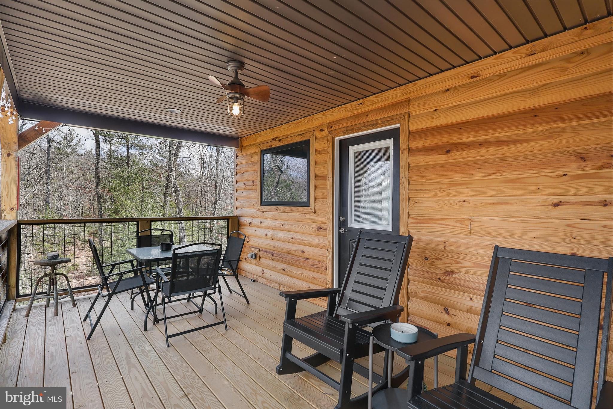 1823 Desert Road Reva, VA 22735 - Photo 24 of 28 a view of a patio with table and chairs and wooden floor