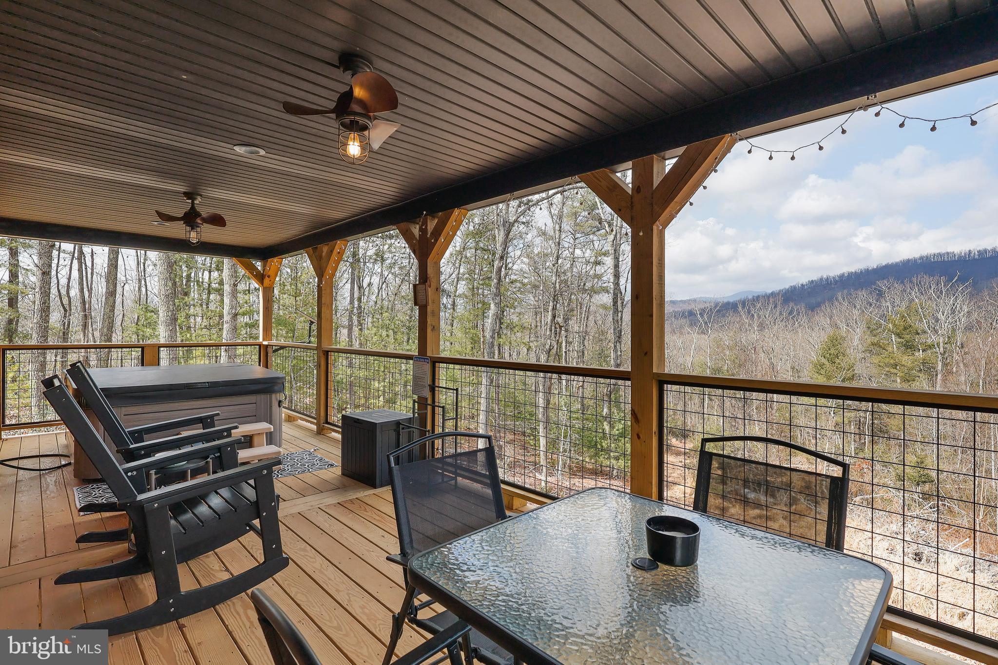 1823 Desert Road Reva, VA 22735 - Photo 26 of 28 a view of a patio with a dining table chairs with wooden floor