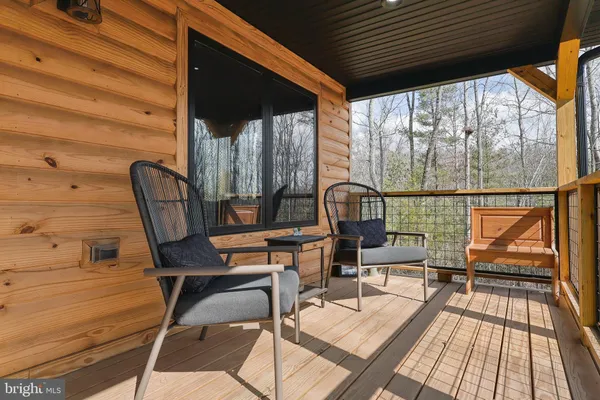 a view of balcony with wooden floor and outdoor seating