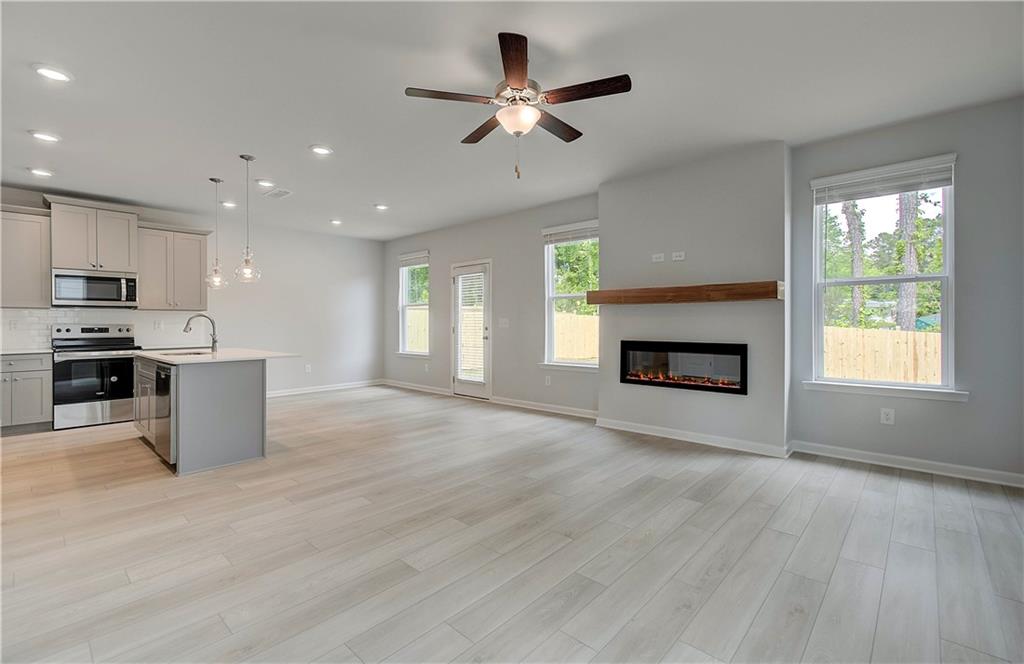 117 Alpine Road Fairburn, GA 30213 - Photo 6 of 29 a view of kitchen with microwave a stove and a window