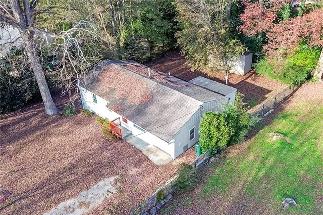 a view of a backyard with large trees