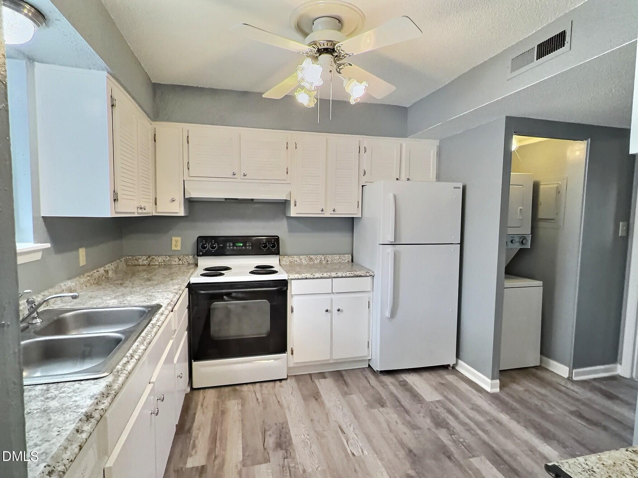 2375 Champion Court Raleigh, NC 27606 - Photo 11 of 31 a kitchen with a refrigerator sink and cabinets