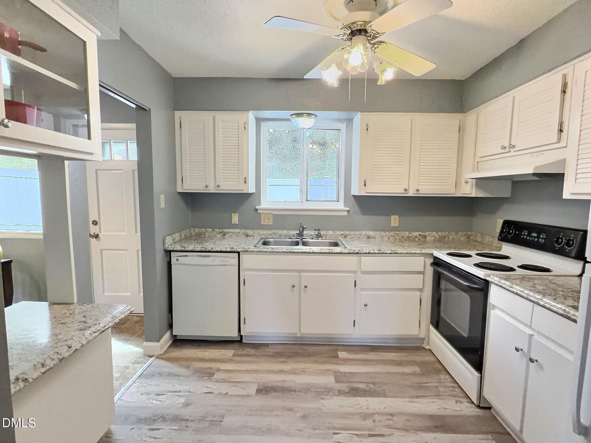 2375 Champion Court Raleigh, NC 27606 - Photo 12 of 31 a kitchen with granite countertop a stove sink and cabinets