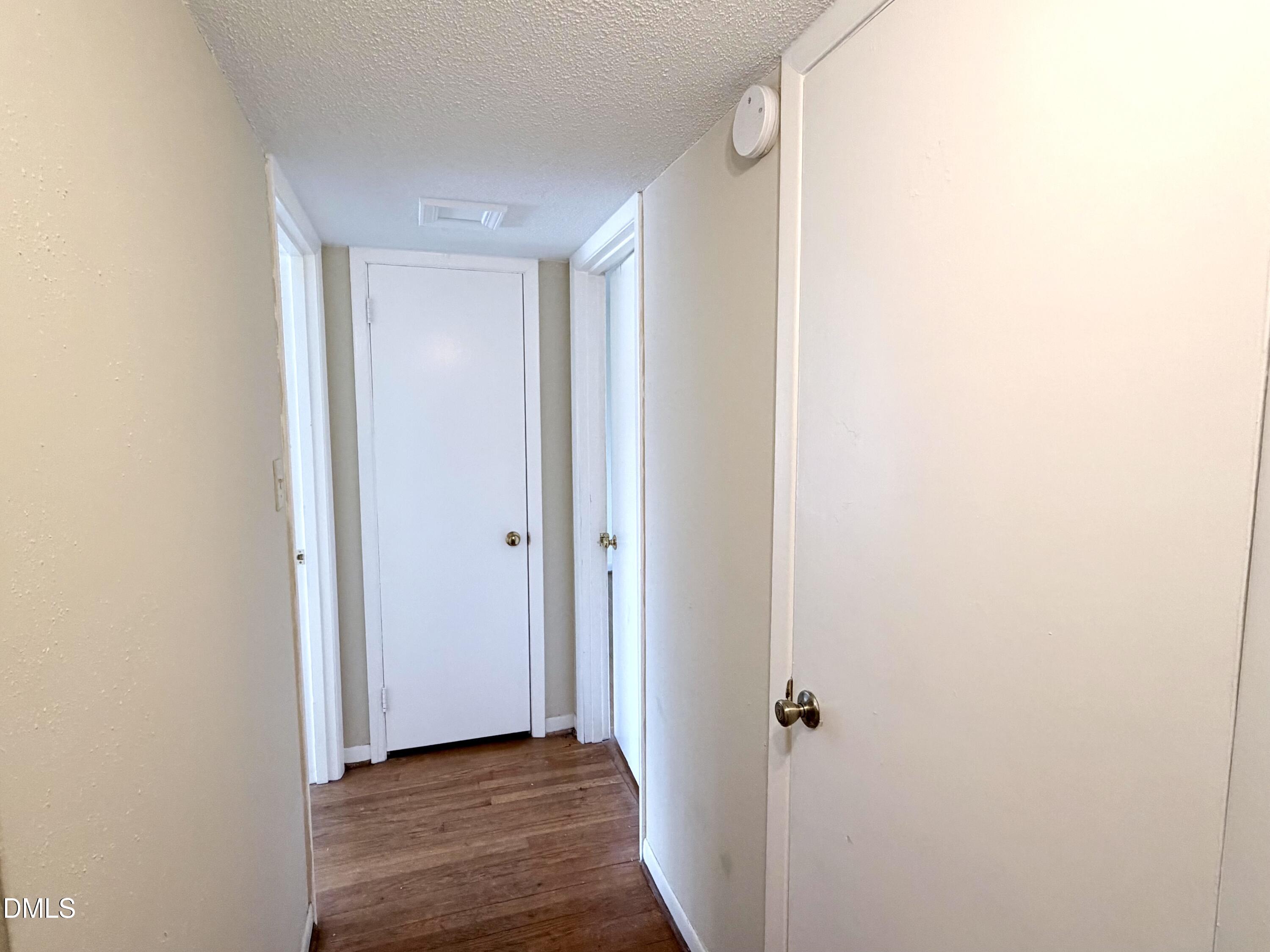 2375 Champion Court Raleigh, NC 27606 - Photo 16 of 31 a view of a hallway with wooden floor