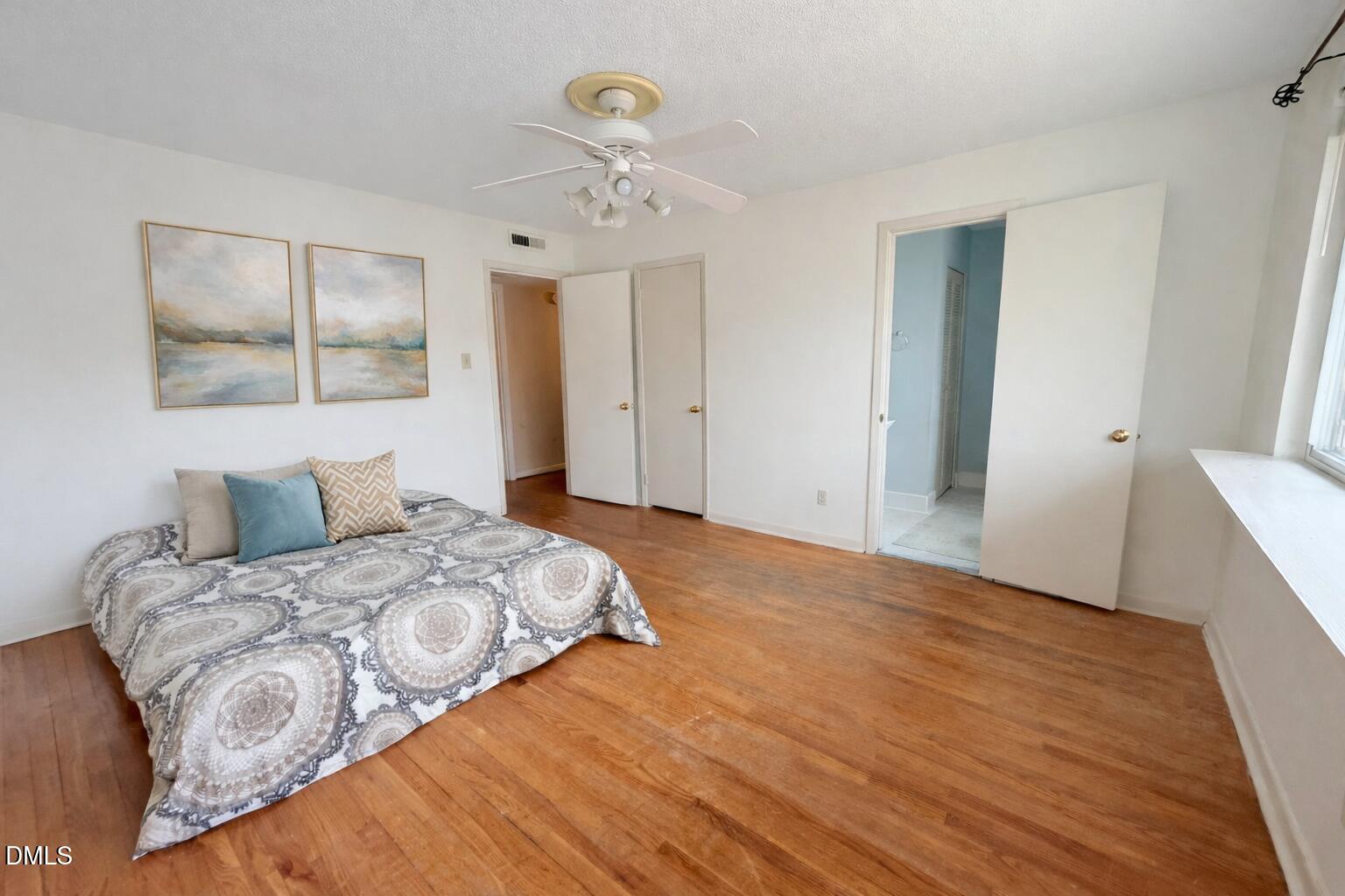2375 Champion Court Raleigh, NC 27606 - Photo 18 of 31 a bedroom with a large bed and wooden floor