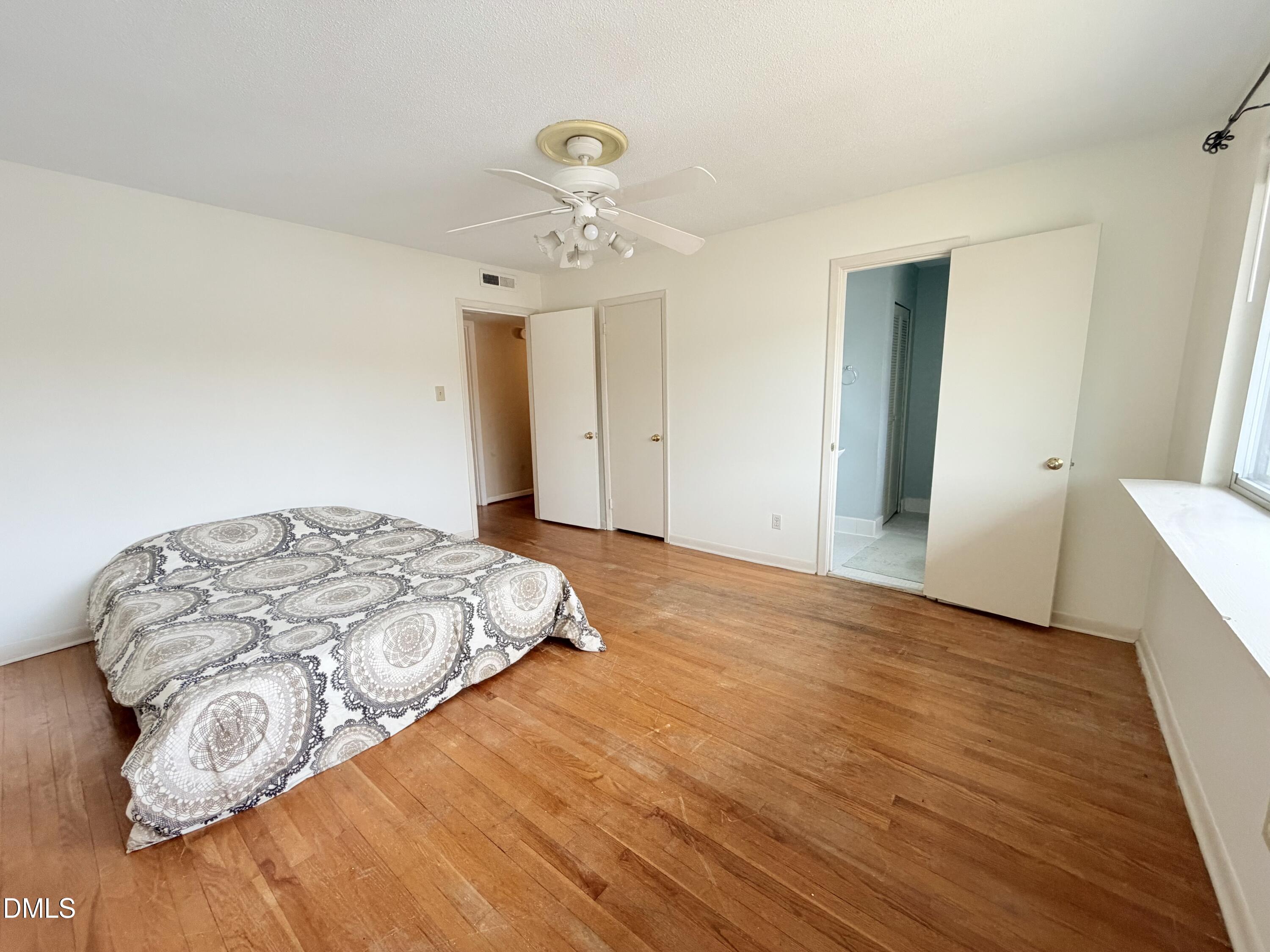 2375 Champion Court Raleigh, NC 27606 - Photo 19 of 31 a bedroom with a bed and a chandelier
