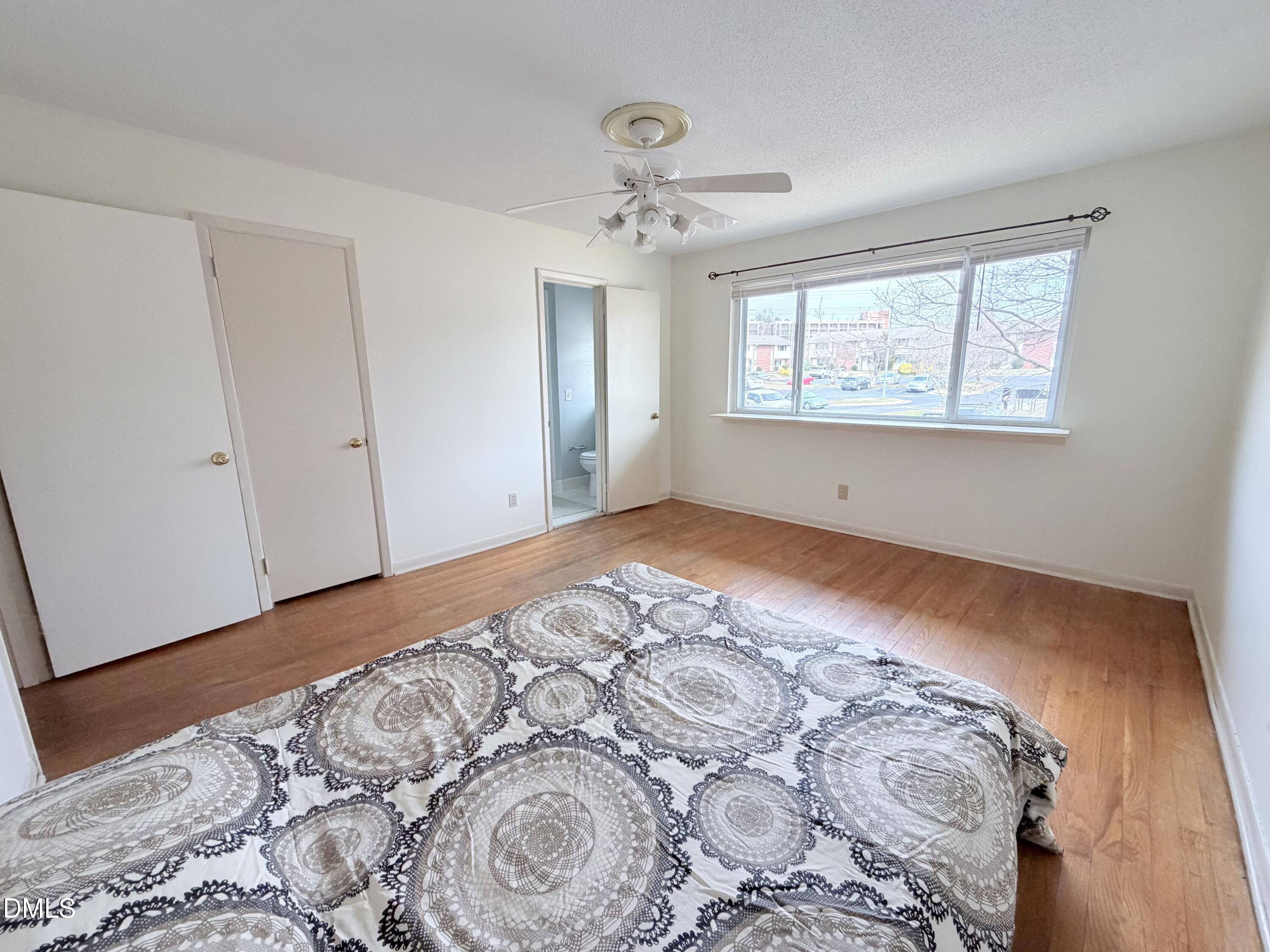 2375 Champion Court Raleigh, NC 27606 - Photo 20 of 31 a view of a big room with wooden floor and windows