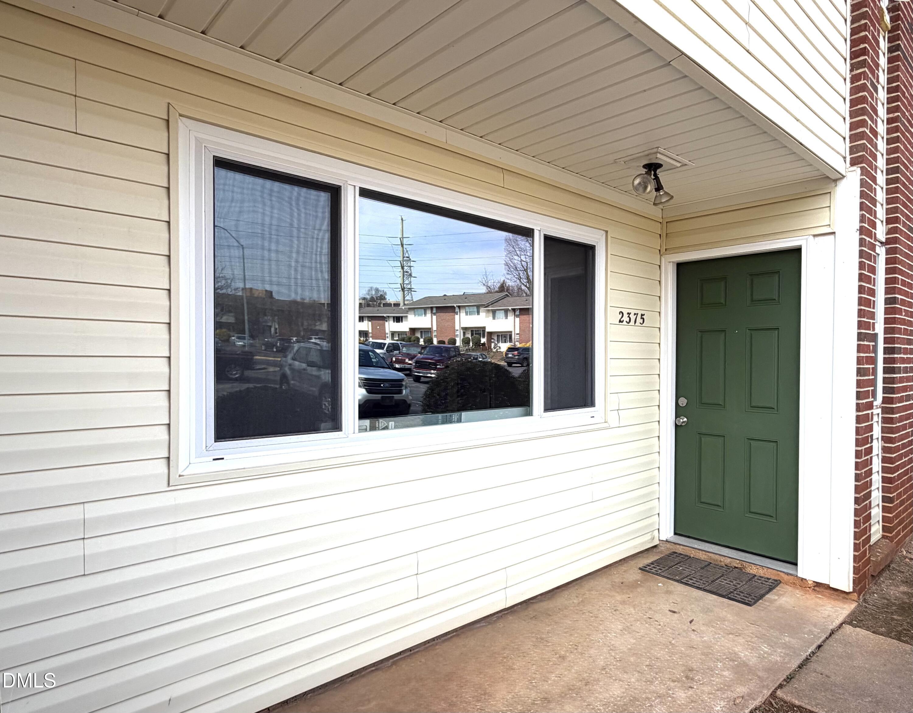 2375 Champion Court Raleigh, NC 27606 - Photo 2 of 31 a view of a porch with a door and wooden floor