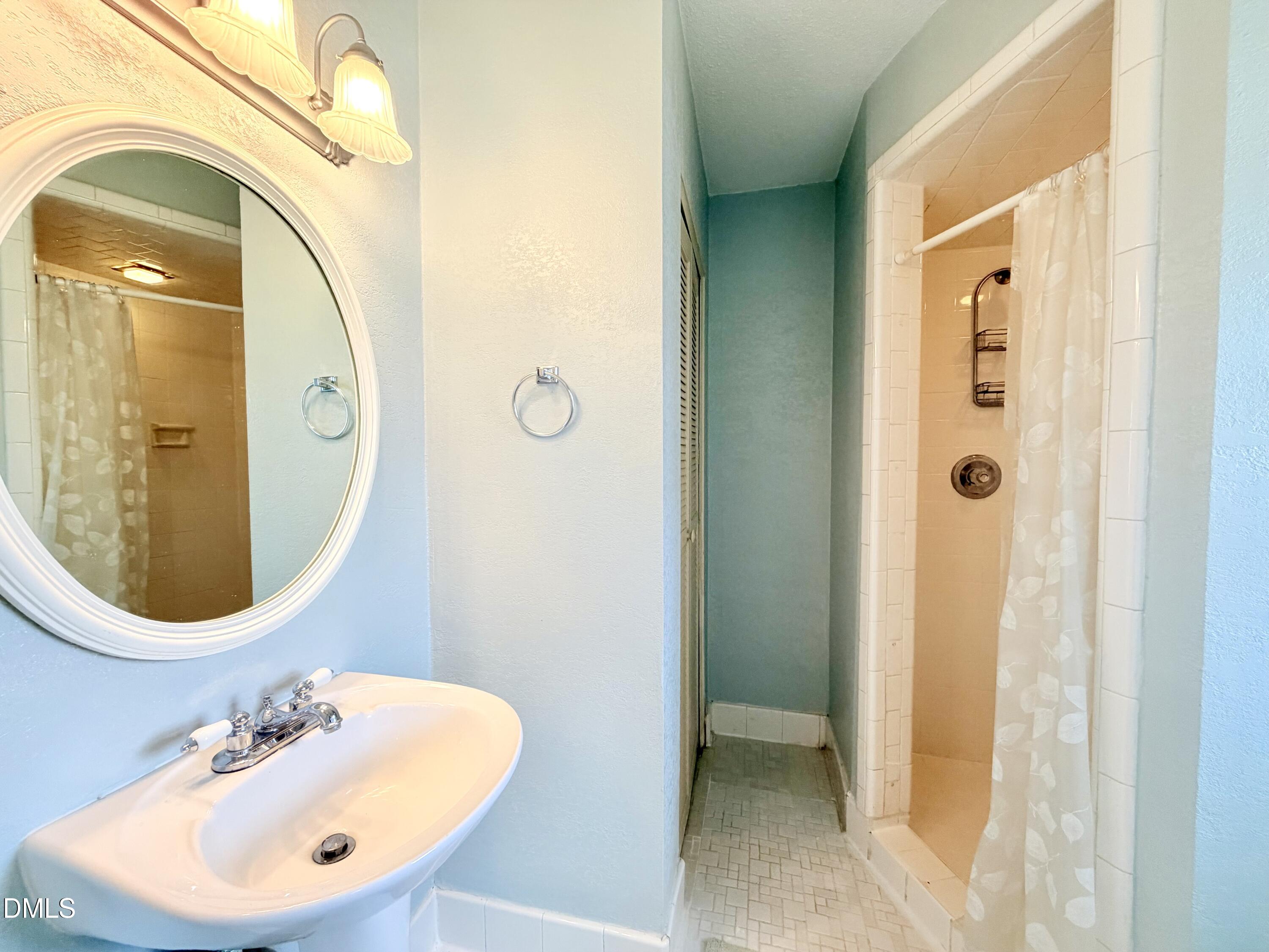 2375 Champion Court Raleigh, NC 27606 - Photo 21 of 31 a bathroom with a sink and a mirror