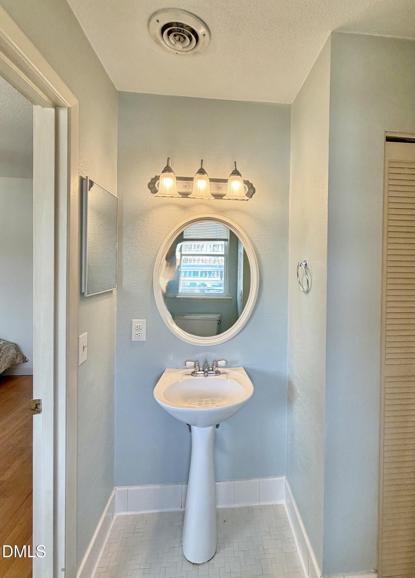 2375 Champion Court Raleigh, NC 27606 - Photo 22 of 31 a bathroom with a sink and a mirror