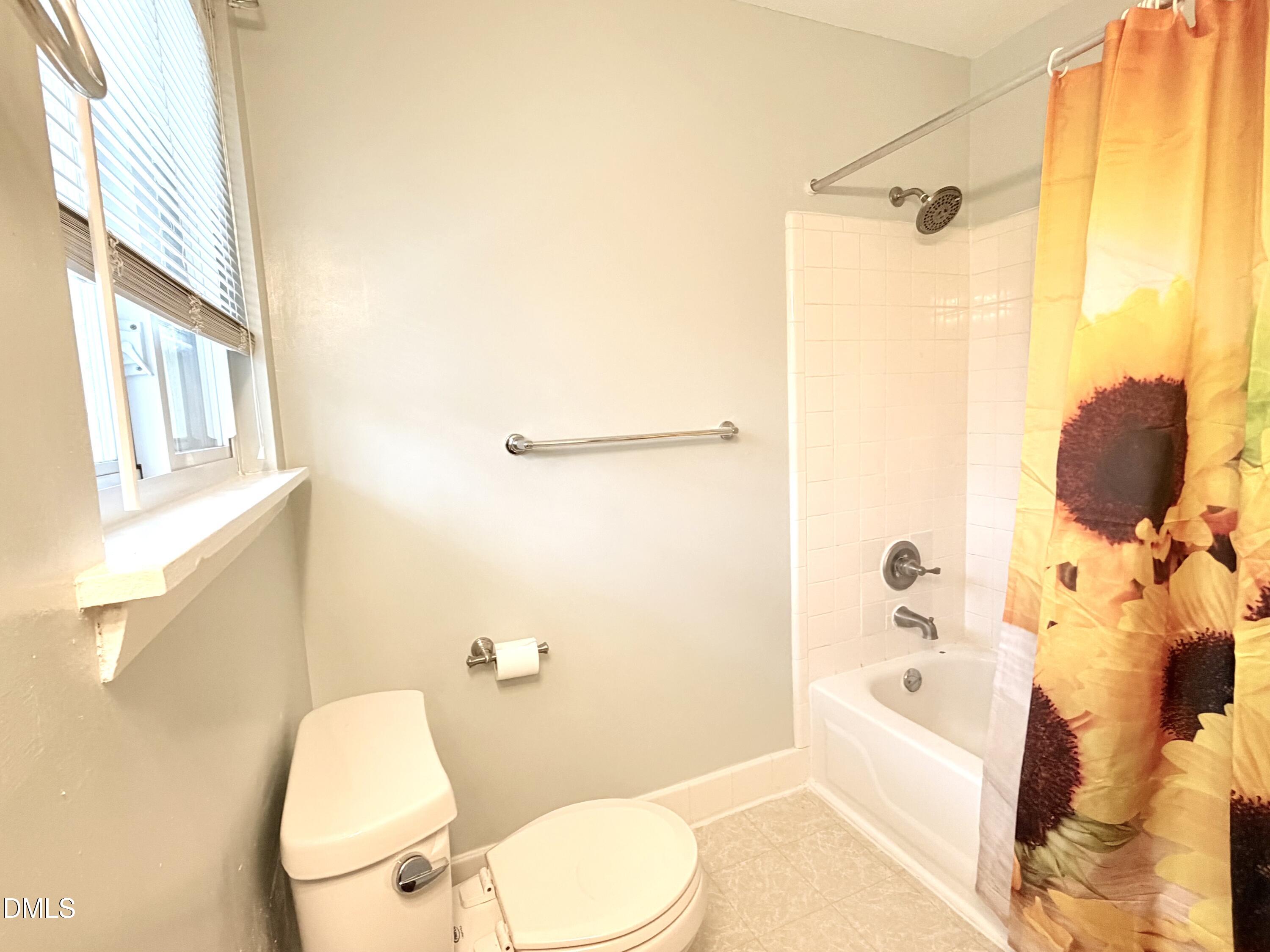 2375 Champion Court Raleigh, NC 27606 - Photo 26 of 31 a bathroom with a sink mirror bathtub and toilet