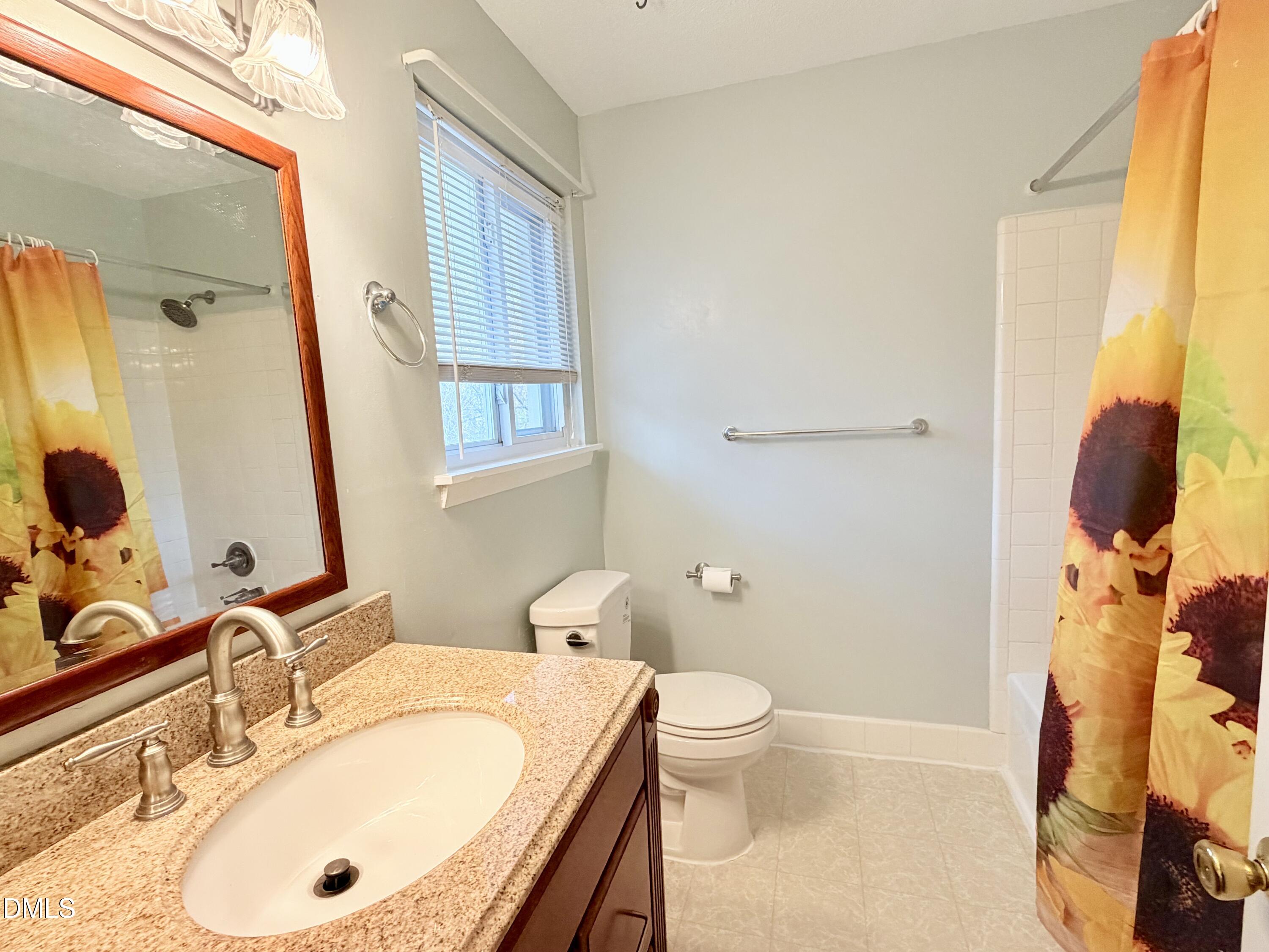 2375 Champion Court Raleigh, NC 27606 - Photo 27 of 31 a bathroom with a sink and a mirror