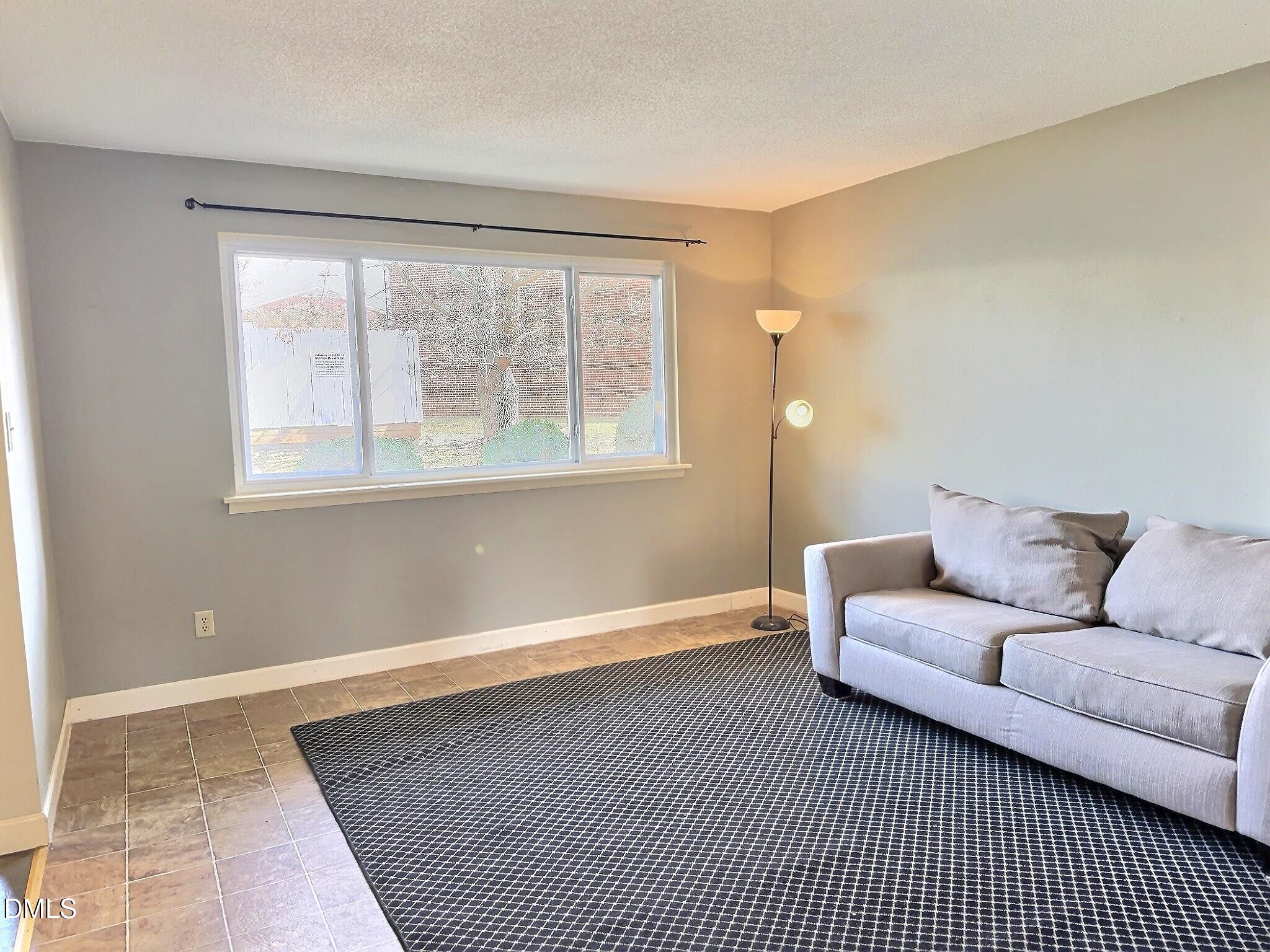 2375 Champion Court Raleigh, NC 27606 - Photo 5 of 31 a living room with a couch and a window