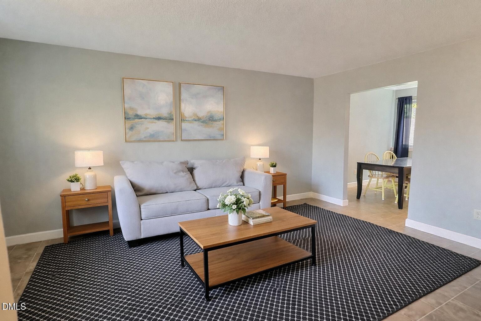 2375 Champion Court Raleigh, NC 27606 - Photo 6 of 31 a living room with furniture a rug a lamp and a table