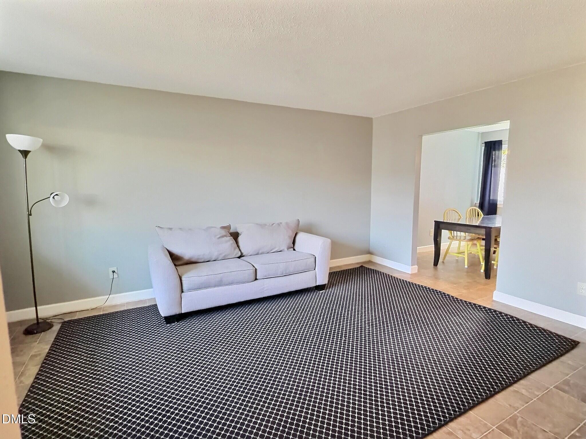 2375 Champion Court Raleigh, NC 27606 - Photo 7 of 31 a living room with furniture and a rug
