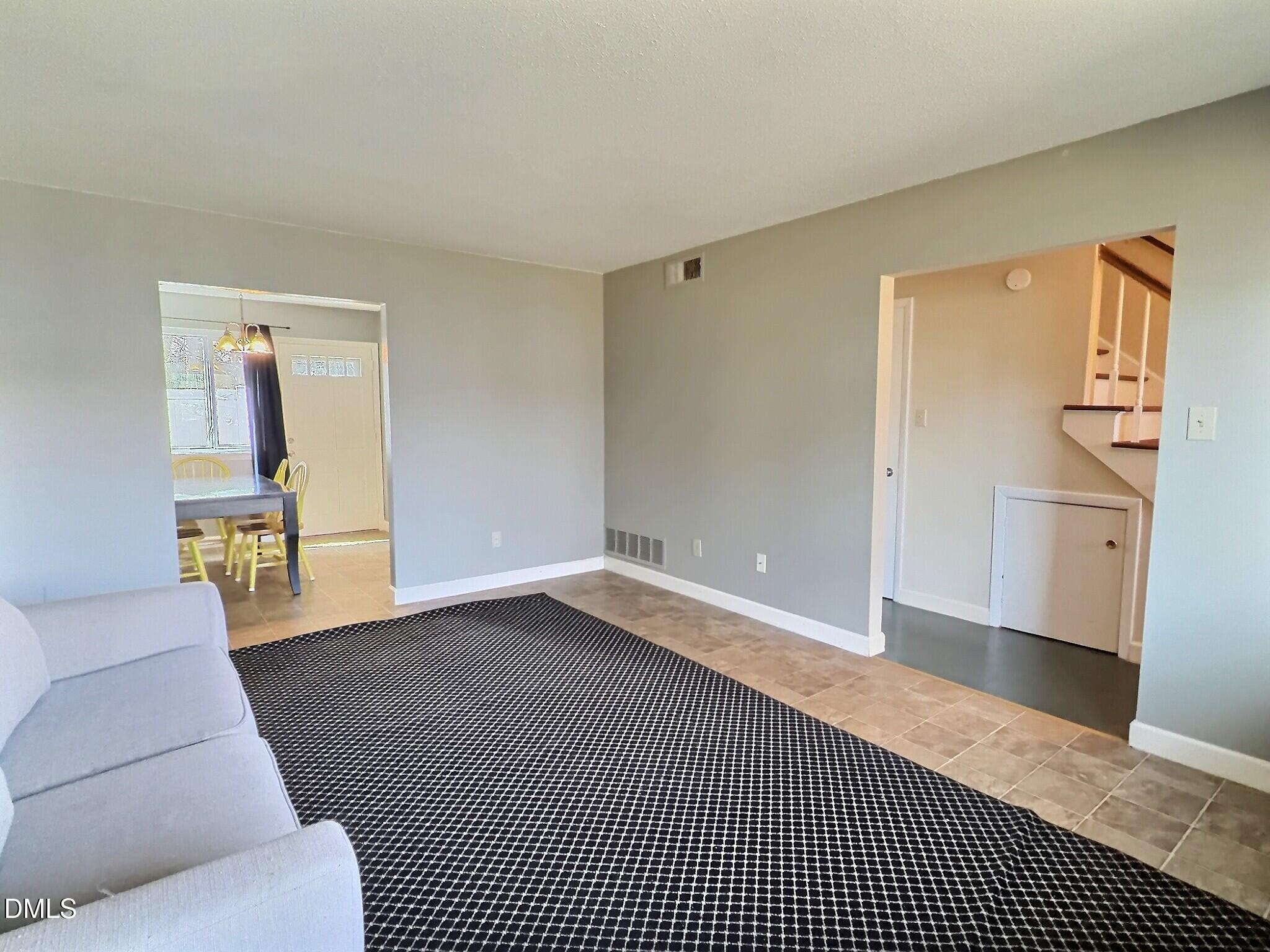 2375 Champion Court Raleigh, NC 27606 - Photo 8 of 31 a living room with furniture and a rug