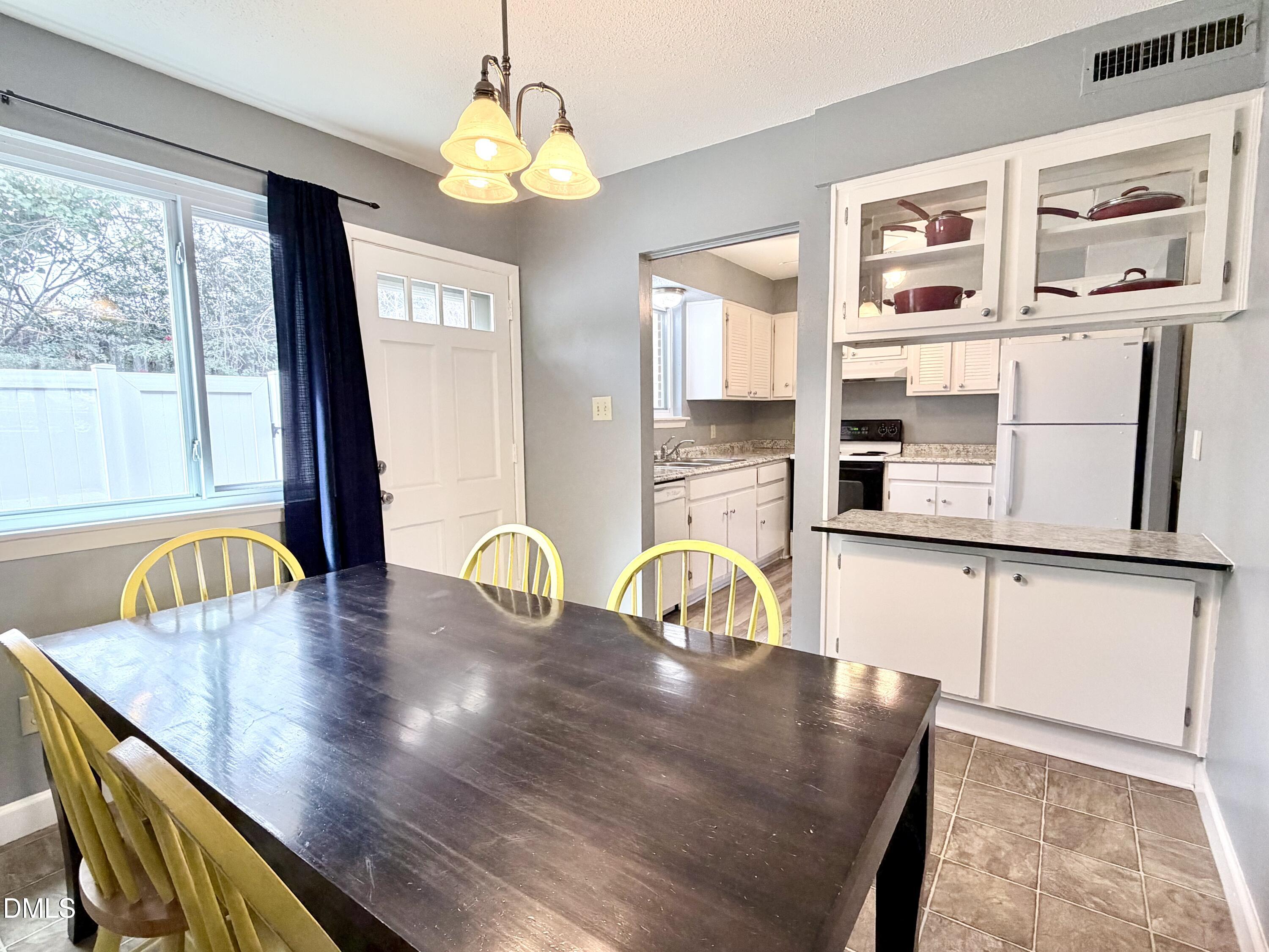 2375 Champion Court Raleigh, NC 27606 - Photo 9 of 31 a dining table with chair and window