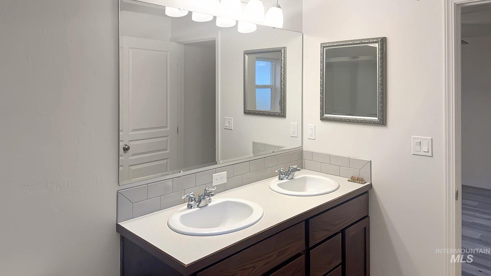 5223 Junegrass Way Caldwell, ID 83607 - Photo 6 of 16 Full bath featuring double vanity and decorative backsplash